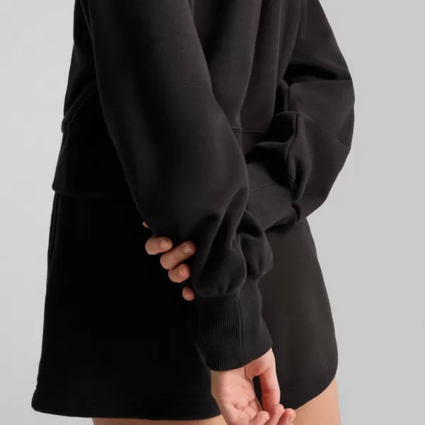  Damske trenirke PUMA WARDROBE ESS RELAXED CROPPED HOODIE TR 629746-01 ČRN 